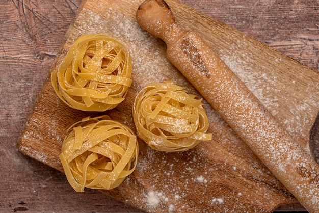 Food photography of raw pasta and wooden board