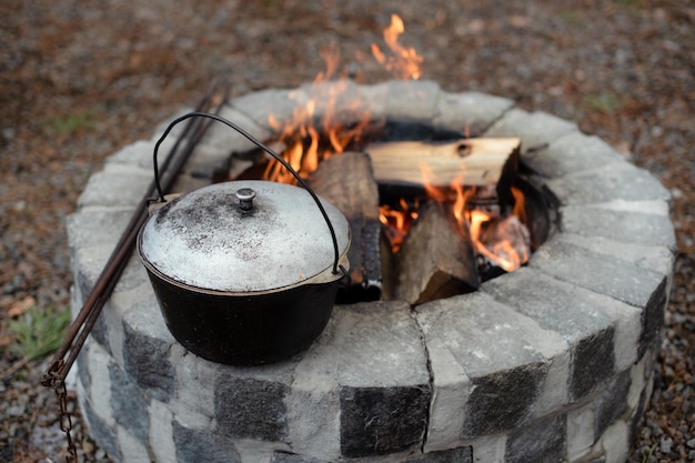 Food in the pot over the fire tourist camp preparing food Camp hot food for tourists in the forest