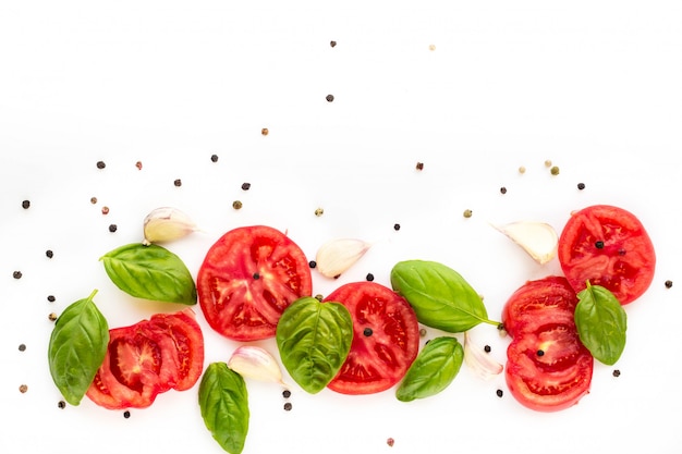 Food of tomato, garlic and basil on white. Top view, copy space