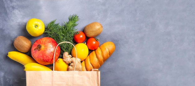 Food various in paper bag on gray background Top view text space