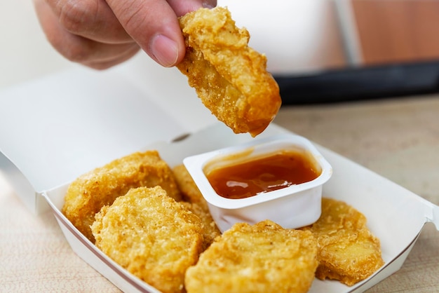 Food at Vkusno and tochka Chicken nuggets and sauce in a new package on a tray on the table Closeup Rebranding of the popular McDonald's fast food chain