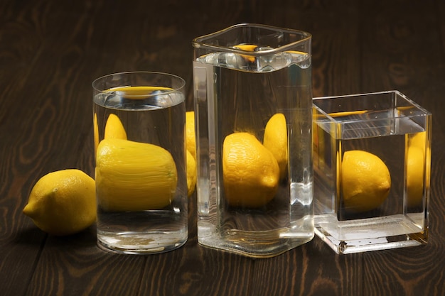 Foods distorted through liquid and glass on dark wooden background