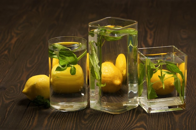 Foods distorted through liquid and glass on dark wooden background