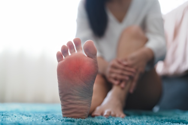 Foot ankle injury pain women touch her foot painful, healthcare and medicine concept 