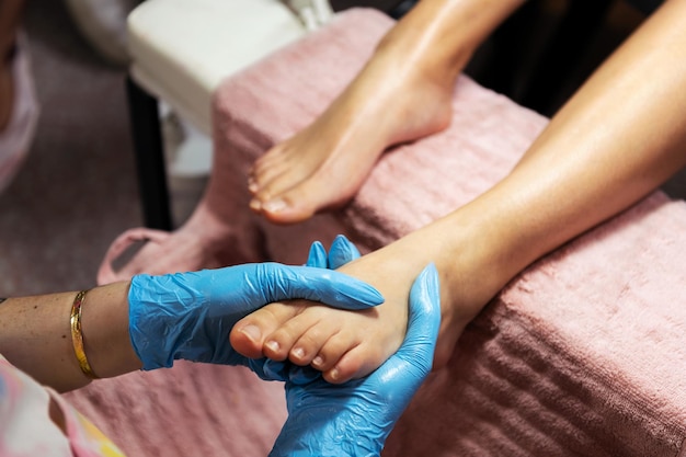 Foot receiving a relaxing massage during pedicure