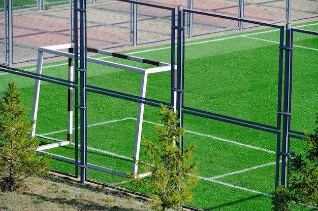 Football field with gate and freshly laid green lawn