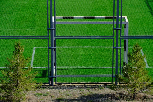 Football field with gate and freshly laid green lawn