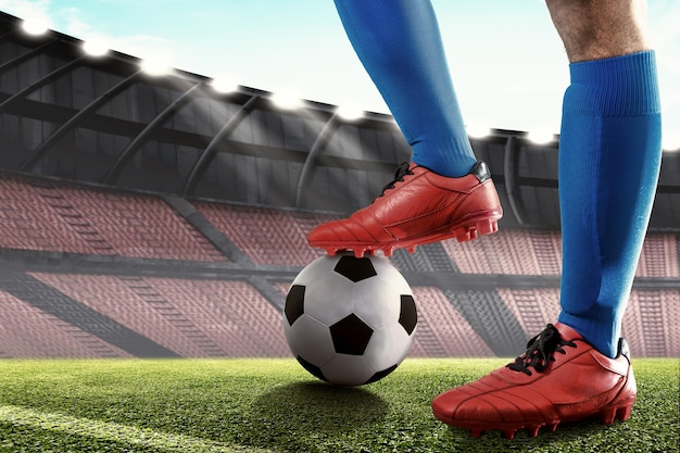 Football player man in a blue jersey standing with the ball