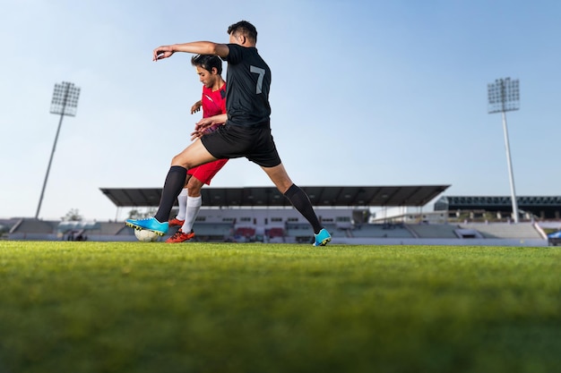 Football player playing ball in the outdoor stadium