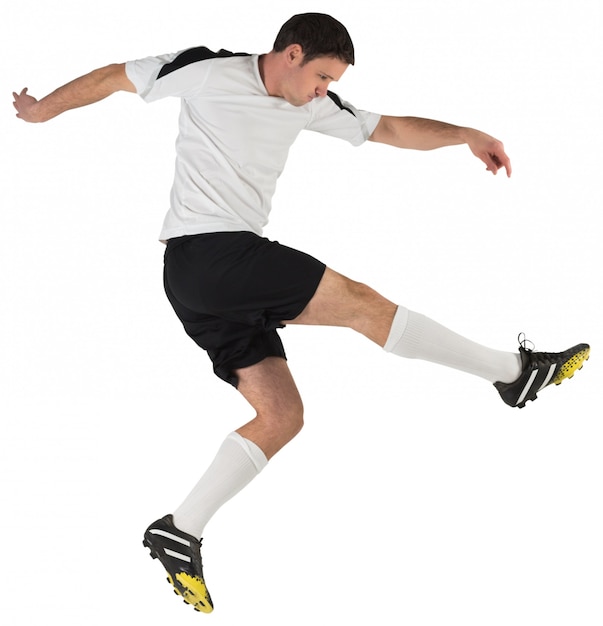 Football player in white kicking on white background