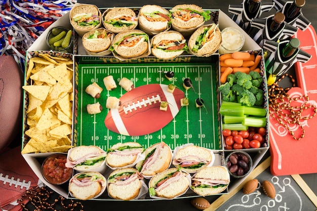 Football Snack Stadium filled with sub sandwiches, veggies and chips.