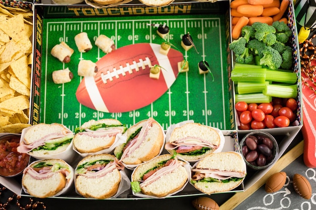 Football Snack Stadium filled with sub sandwiches, veggies and chips.