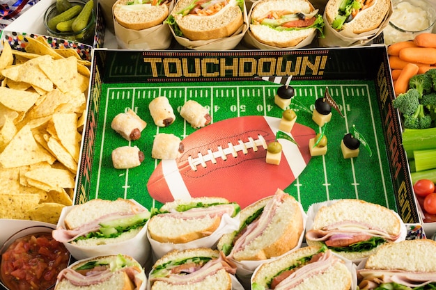 Football Snack Stadium filled with sub sandwiches, veggies and chips.