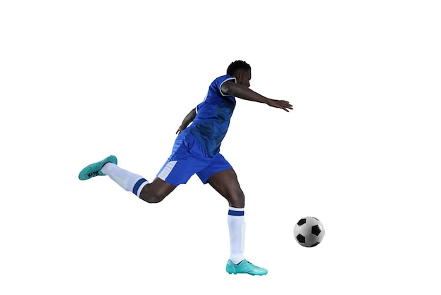 Football striker with blue team suit chases the soccerball