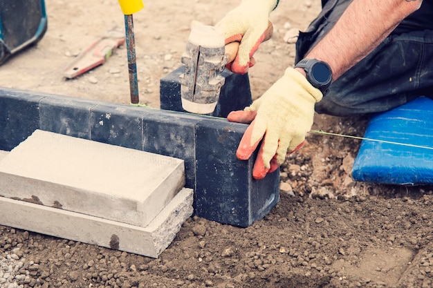 Footpath under construction Builder installing new kerbs on concrete closeup