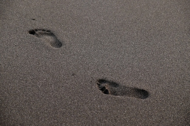 Footprints on beach during sunset on summertime