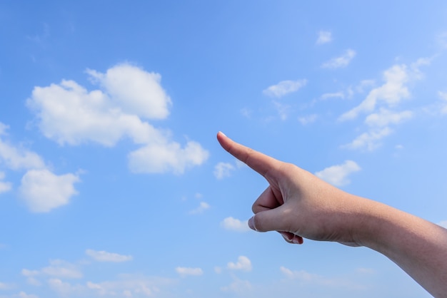 Forefinger with sky and cloud