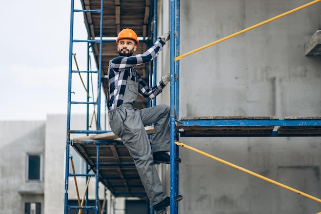 Foreman climbing ladder at building object