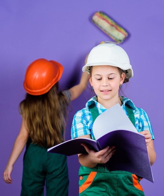 Foreman inspector Repair engineering idea Future career Little kids in helmet with tablet and roller Labor day 1 may small girls repairing together in workshop Repairing is what I do well