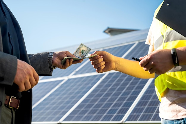 Foreman receives a salary from a businessman after work on the installation of solar panels