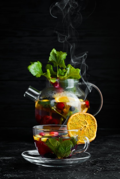 Forest berry and fruit tea Hot winter drinks On a black background Top view