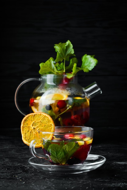 Forest berry and fruit tea Hot winter drinks On a black background Top view