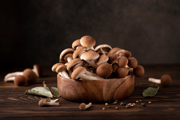 Forest mushrooms honey agarics in a wooden bowl, close-up