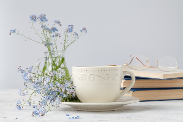 Forget-me-nots flowers on book, on wooden wall