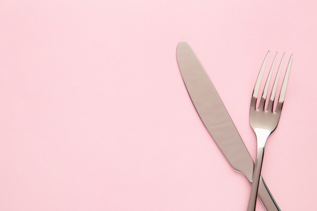 Photo fork and knife isolated on pink