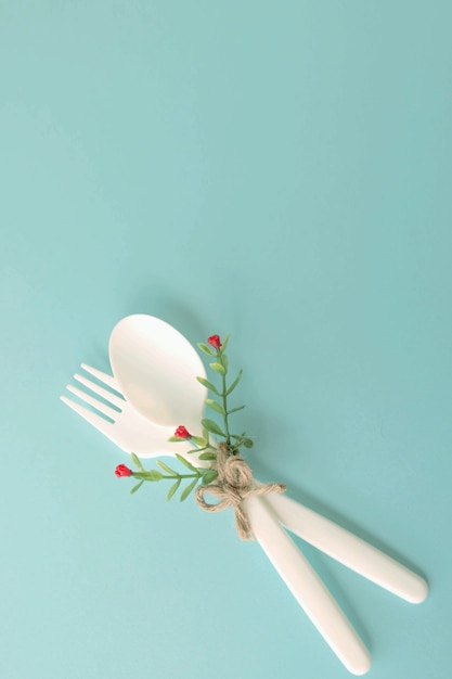 Fork and spoon plastic isolated on blue background