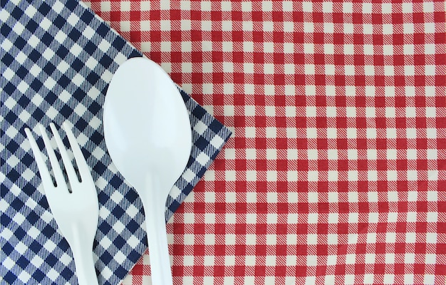 Fork and spoon on tablecloth for food serving background 