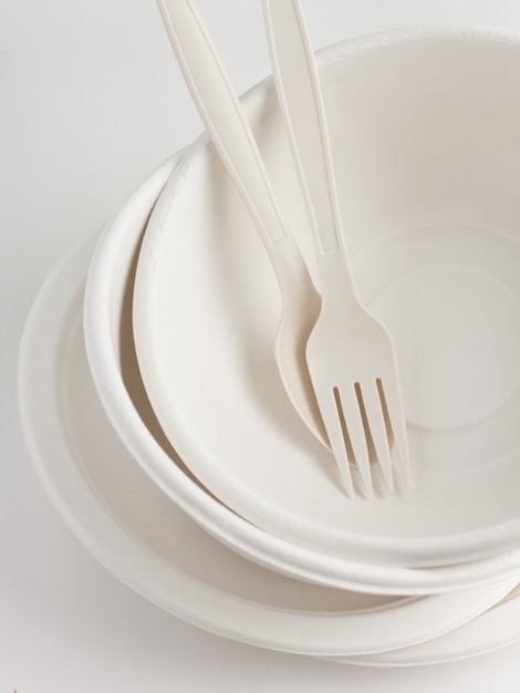 Fork and spoon with disposable paper plate for party