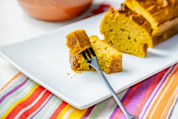 Photo fork with piece of wet carrot pudding