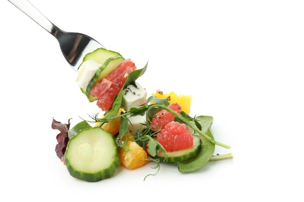 Fork with salad with red orange isolated on white background