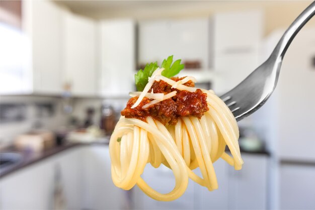 Fork with tasty pasta, close-up