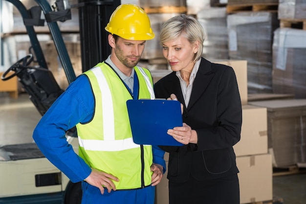 Forklift driver talking with his manager