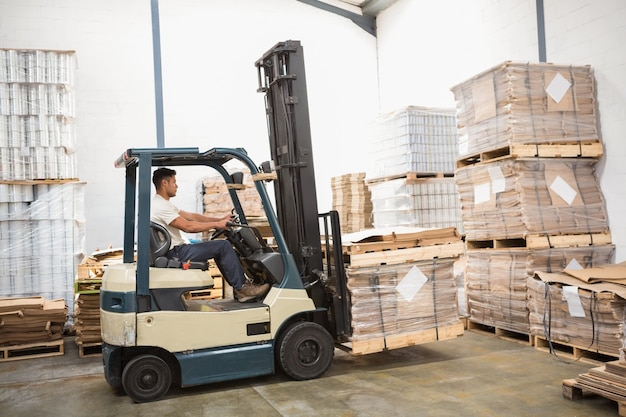 Forklift machine in a large warehouse