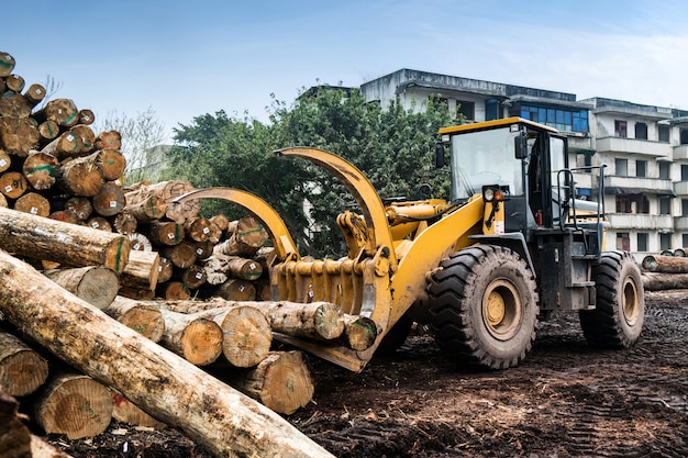 Forklift truck grabs wood in a wood processing plant