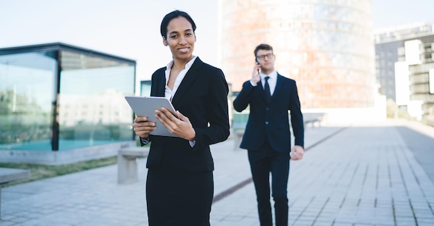 Formal businesswoman smiling at camera on street