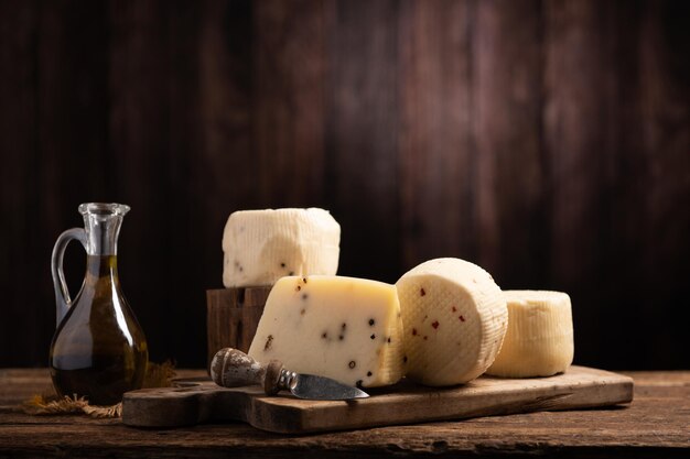 Forms of homemade pecorino cheese on wooden table close up