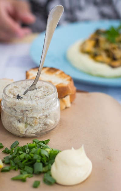 Forshmak with green onion and toasted bread. Seafood restaurant. Toast with herring mousse.