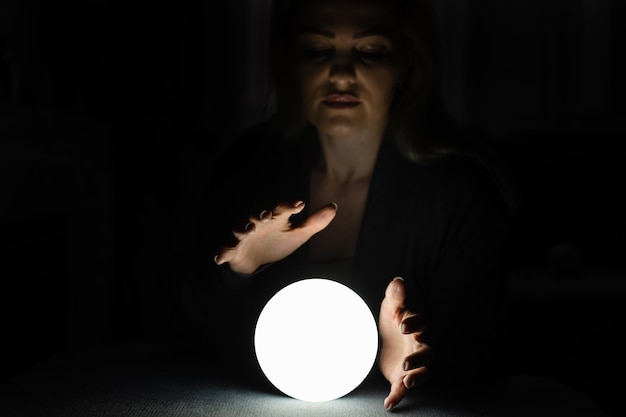 A fortune teller gazes into her ball.