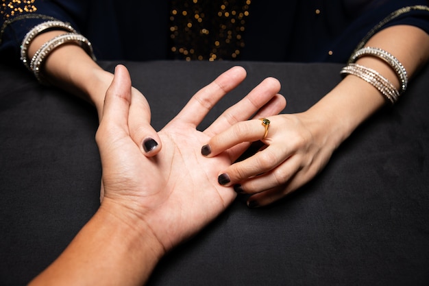 Fortune teller reading fortune lines on hand