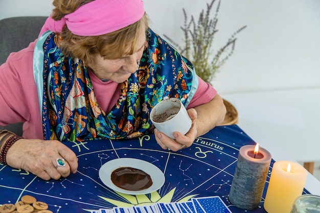 A fortune teller reads fortunes on coffee grounds Selective focus