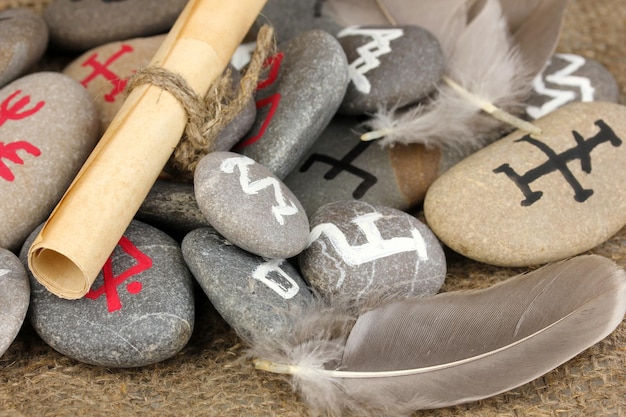 Fortune telling with symbols on stones on burlap background