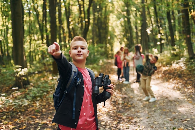 Founding the way Kids in green forest at summer daytime together