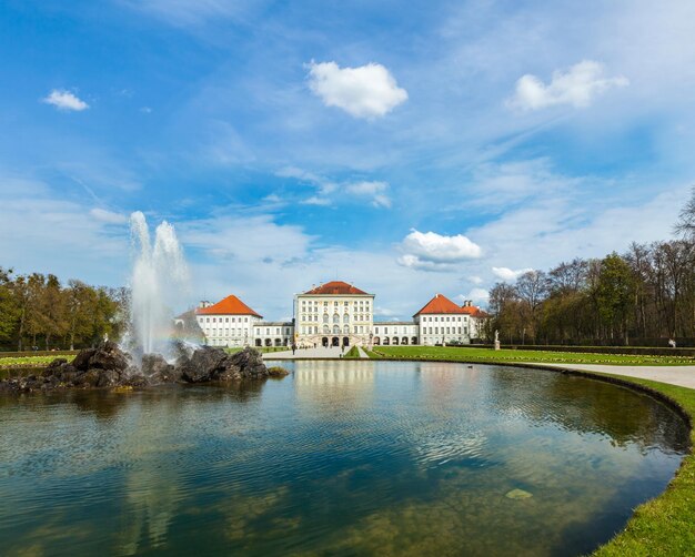 Fountain in Grand Parterre Baroque garden and the rear view of the Nymphenburg Palace Munich Bavaria Germany