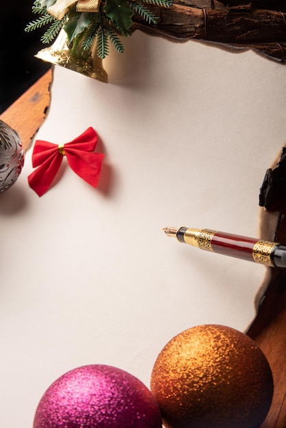 Fountain pen a beautiful fountain pen a blank sheet with burnt edges and Christmas ornaments Selective focus