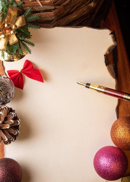 Fountain pen a beautiful fountain pen a blank sheet with burnt edges and Christmas ornaments Selective focus