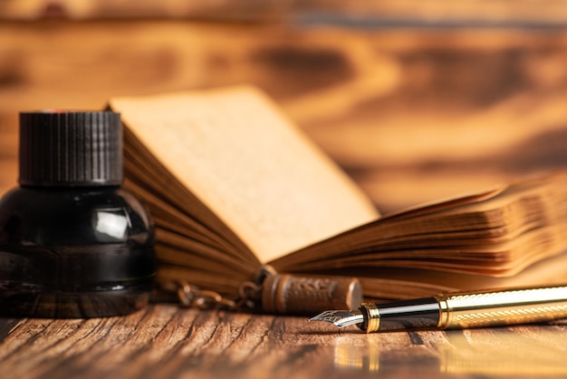 Fountain pen beautiful fountain pen in an environment with an old clock old book ink among others selective focus